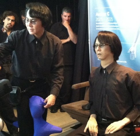 Roboticist Hiroshi Ishiguro of Osaka University (left) demos his "Geminoid" android lookalike (right) at the Global Futures 2045 International Congress in New York.