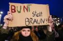 Counter protester holds up a sign during a demonstration called by anti-immigration group PEGIDA, in Dresden