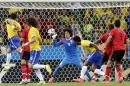 Mexico's goalkeeper Guillermo Ochoa (13) bats the ball away after a header by Brazil's Fred, left, during the group A World Cup soccer match between Brazil and Mexico at the Arena Castelao in Fortaleza, Brazil, Tuesday, June 17, 2014. (AP Photo/Marcio Jose Sanchez)