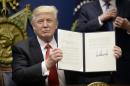 Trump defends travel ban amid fierce backlash
