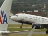 A US airways plane takes off behind an American Airlines jet at Ronald Reagan National Airport in Washington