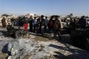 Residents gather at the site of a car bomb attack in the Shuala district in Baghdad