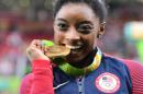 US gymnast Simone Biles celebrates with her gold medal after the women's individual all-around final in Rio on August 11, 2016
