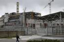 A man walks in front of the sarcophagus covering the damaged fourth reactor at the Chernobyl nuclear power plant