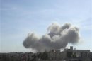 Smoke rises from what activists say was a missile fired by a Syrian Air Force fighter jet loyal to Syria's President Bashar al-Assad at Erbeen