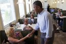 FILE - In this Aug. 23, 2013, file photo, President Barack Obama greets patrons at Bingham's Family Restaurant, where he stopped to buy pie, in Lenox, Pa. Obama still calls shoring up the middle class his 