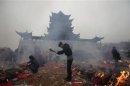 File photo of worshippers burning incense to pray for wealth on the fifth day of Chinese Lunar New Year at Guiyuan Buddhist Temple in Wuhan