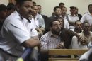 Friends of Egyptian suspects react as they listen to the judge's verdict at a court room during a case against foreign non-governmental organisations in Cairo