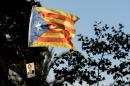 An "Estelada" with a picture of Catalonia's regional government president and leader of the Catalan Democratic Convergence party Artur Mas reading "Artur Mas imputed by 9n" is waved as he arrives at the TSJC on October 15, 2015 in Barcelona