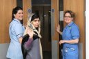 Pakistani schoolgirl Malala Yousufzai (C) waves with nurses as she is discharged from The Queen Elizabeth Hospital in Birmingham in this handout photograph released on January 4, 2013