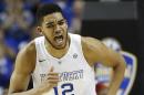 FILE - In this March 15, 2015, file photo, Kentucky forward Karl-Anthony Towns (12) celebrates his shot against Arkansas during the first half of the Southeastern Conference tournament championship game in Nashville, Tenn. Towns is a top prospect in the NBA draft on Thursday, June 25, 2015. (AP Photo/Steve Helber, File)