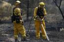 Firefighters mop up a hotspot during the Rocky Fire near Clearake, California