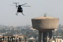 A helicopter belonging to then-Blackwater scans the streets of central Baghdad in 2005