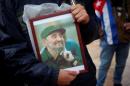 A supporter holds an image of former Cuban leader Fidel Castro at a tribute in Malaga