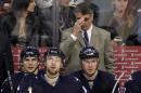 Claude Noel, head coach of the Winnipeg Jets, adjusts his glasses on the bench in third period action in an NHL game against the Columbus Blue Jackets at the MTS Centre on January 11, 2014 in Winnipeg, Manitoba, Canada