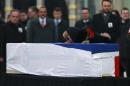 The wife, name not available, of Russian Ambassador to Turkey Andrei Karlov who was assassinated Monday, cries over her husband's coffin, draped in the Russian flag, during a ceremony at the airport in Ankara, Turkey, Tuesday, Dec, 20, 2016. (AP Photo/ Emrah Gurel)
