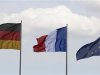 Flags of Germany, France and the European Union flutter in the wind before the meeting of new French President Hollande and German Chancellor Merkel in Berlin