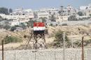 An Egyptian soldier stands guard on a watchtower near the border between Egypt and the Gaza Strip on September 12, 2013