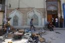 A member of the Iraqi security forces stands guard outside a Shi'ite mosque after a bomb attack in Baghdad
