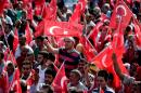 People wave the Turkish national flag at an "anti-terorrism" rally in Istanbul on September 20, 2015