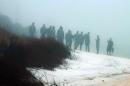 Military personnel wade in the water and search on the beach under heavy fog at Eglin Air Force Base, Fla., Wednesday, March 11, 2015, for the wreckage of a military helicopter that crashed with 11 service members aboard. The helicopter went down Tuesday evening. A Pentagon official says all aboard are presumed dead. (AP Photo/Melissa Nelson-Gabriel)