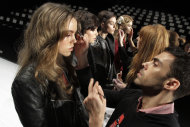 FILE - In this Feb. 15, 2012, file photo, models have their make-up finalized under runway light before the J. Mendel Fall 2012 collection is modeled during Fashion Week, in New York. The 19 editors of Vogue magazines around the world made a pact to project the image of healthy models. They agreed to "not knowingly work with models under the age of 16 or who appear to have an eating disorder" and they will ask casting directors to check IDs at photo shoots, fashion shows and for ad campaigns, according to a Conde Nast International announcement Wednesday.(AP Photo/Richard Drew, file)