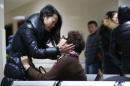 Relatives of a victim hug as they wait at a hospital where injured people of a stampede incident are treated in Shanghai