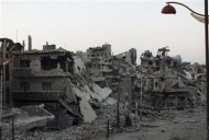 A general view shows damaged buildings on a deserted street in the besieged area of Homs July 12, 2013. REUTERS/Yazan Homsy