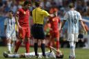 Argentina's Angel di Maria lies on the ground injured as referee Nicola Rizzoli from Italy requests a stretcher to take him off the pitch during the World Cup quarterfinal soccer match between Argentina and Belgium at the Estadio Nacional in Brasilia, Brazil, Saturday, July 5, 2014. At left is Belgium's Axel Witsel and at right, Argentina's Lucas Biglia.(AP Photo/Eraldo Peres)