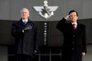 U.S. Defense Secretary James Mattis and his South Korean counterpart Han Min-Koo salute to the national flag at the Defense Ministry in Seoul