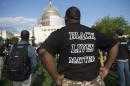 A man wears a "Black Lives Matter" t-shirt as he demonstrates in a rally for criminal justice reform legislation to end racial profiling and demilitarize police forces outside the US Capitol in Washington, DC, April 21, 2015
