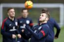 England midfielder Jack Wilshere (R) prepares to head a ball during a training session at Tottenham Hotspur's training complex in Enfield, north London, on March 3, 2014