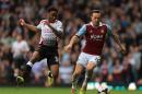 Liverpool's Raheem Sterling (left) and West Ham United's Mark Noble (right) battle for the ball during their English Premier League match at Upton Park, London, Sunday April 6, 2014. (AP Photo / Nick Potts,PA) UNITED KINGDOM OUT NO SALES NO ARCHIVE