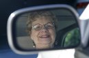 In this photo taken Sept. 12, 2012, Sandy Wiseman is reflected in the rearview mirror in Schaumburg, Ill. Jerry Wiseman and his wife, Sandy, took refresher driving classes to help them stay safe behind the wheel for many more years. More older drivers are on the road, and they face a hodgepodge of state licensing rules that reflect scientific uncertainty and public angst over a growing question: How can we tell if it's time to give up the keys? (AP Photo/Charles Rex Arbogast)