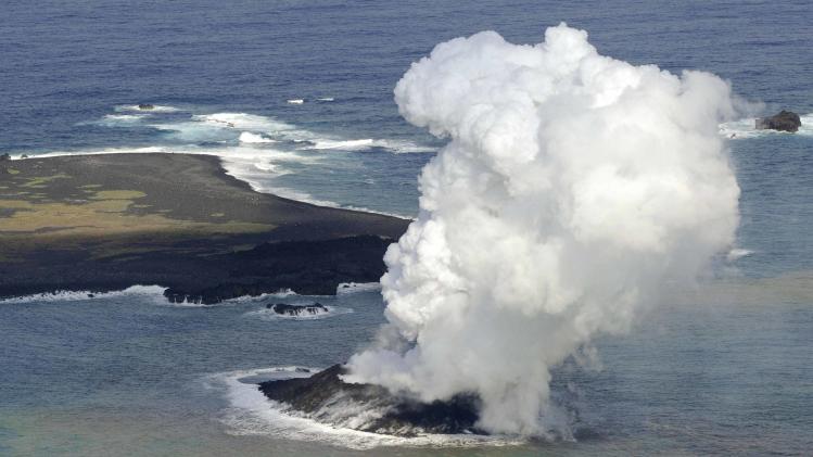Smoke from an erupting undersea volcano forms a new island off the coast of Nishinoshima in the southern Ogasawara chain of islands