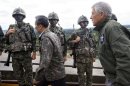 U.S. Secretary of Defense Hagel walks past South Korean soldiers with South Korea's Defence Minister Kim during a tour of the DMZ in Panmunjom