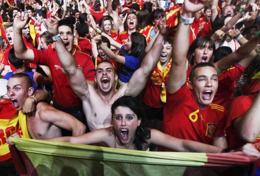 Spanish soccer fans celebrate their victory in the Euro 2012 soccer championship semifinal match between Spain and Portugal at the Fan Zone in Madrid, Spain, Wednesday, June 27, 2012. Spain beat Portugal 4-2 in a penalty shootout on Wednesday to reach the final of Euro 2012. (AP Photo/Andres Kudacki)