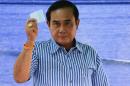 Thai Prime Minister Prayuth Chan-ocha casts his ballot at a polling station during a constitutional referendum vote in Bangkok