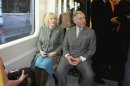 Britain's Prince Charles and his wife Camilla, Duchess of Cornwall, travel on a London Underground tube train
