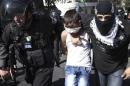 Israeli police detain a Palestinian youth in East Jerusalem