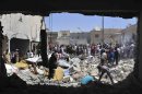 Men search for survivors amid debris of collapsed buildings after what activists said was an air raid by forces loyal to Syria's President Bashar al-Assad in Raqqa province, eastern Syria