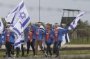 Young jewish people from Israel and other countries march in silence between the two parts of Auschwitz-Birkenau, the Nazi German death camp, in an annual march of the living in Oswiecim, Poland, on Monday, April 28, 2014, which is held in memory of some 6 million Jews killed during the Holocaust. This year, the march honors some 430,000 Hungarian Jews killed in Birkenau gas chambers in 1944. (AP Photo/Czarek Sokolowski)