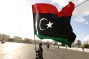 A Libyan man waves his national flag in the eastern coastal city of Benghazi on February 27, 2015