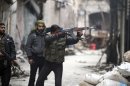 A Free Syrian Army fighter fires his weapon towards positions occupied by forces loyal to Syria's President Assad in the old city of Aleppo