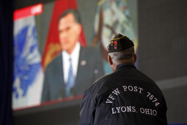 Vietnam veteran David Snyder of Metamora, Ohio, watches a live video broadcast of Republican presidential candidate, former Massachusetts Gov. Mitt Romney, at a campaign event with Republican vice presidential candidate, Rep. Paul Ryan, R-Wis., Monday, Oct. 8, 2012, in Swanton, Ohio. (AP Photo/Mary Altaffer)