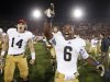 Notre Dame running back Theo Riddick, right, and wide receiver Luke Massa, left, celebrate after Notre Dame defeated Southern California 22-13 in an NCAA college football game, Saturday, Nov. 24, 2012, in Los Angeles. (AP Photo/Danny Moloshok)