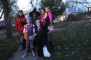 Republican vice presidential candidate, Rep. Paul Ryan, R-Wis., poses for a photo with his family, from left, Charlie dressed up as the Unknown Phantom, Liza as Katy Perry, Janna, as a witch, Sam as the Grim Reaper, his sister-in-law Zoe Ryan and her daughter Zaydee May while out trick or treating, Wednesday, Oct. 31, 2012, in Janesville, Wis. (AP Photo/Mary Altaffer)