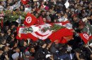 Soldiers help mourners carry the coffin of slain opposition leader Chokri Belaid during his funeral procession towards the nearby cemetery of El-Jellaz, where he is to be buried, in the Jebel Jelloud district of Tunis