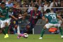 Barcelona's Luis Suarez from Uruguay fights for the ball against Leon's Luis Antonio Delgado, left, and Jonny Magallon, during the Joan Gamper trophy friendly soccer match between Barcelona and Leon at the Camp Nou stadium in Barcelona, Spain, Monday, Aug. 18, 2014. (AP Photo/Emilio Morenatti)