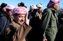 Kurdistan Iraqi regional government President Massoud Barzani arrives to support Kurdish forces as they head to battle Islamic State militants, on the summit of Mount Sinjar, in the town of Sinjar, Iraq, Sunday, Dec. 21, 2014. Iraqi Kurdish fighters pushed their way Sunday into the town of Sinjar, backed by U.S.-led coalition airstrikes against Islamic State militants who captured the town last summer. Loud explosions and intense gunbattles were heard from inside the town. Barzani vowed to crush the Islamic State group as fighting rages in Sinjar. (AP Photo/Zana Ahmed)